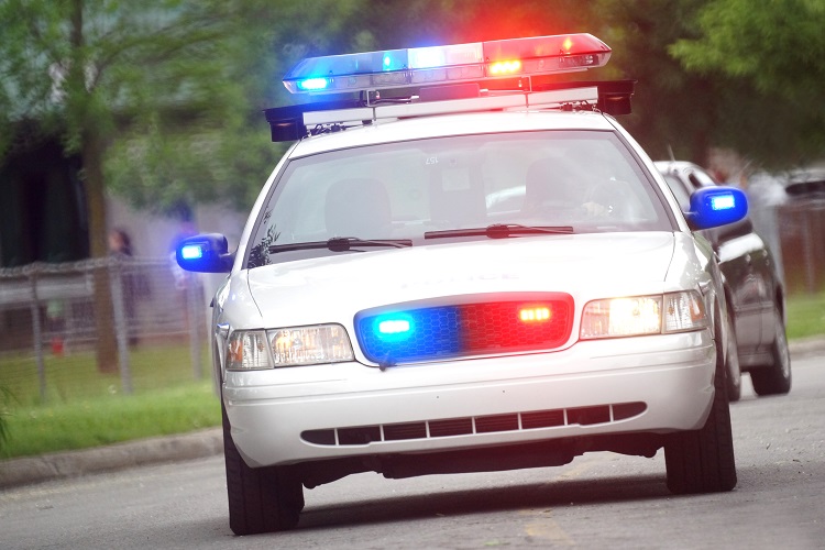 Police car patrolling city streets