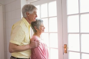 Senior couple looking out their window