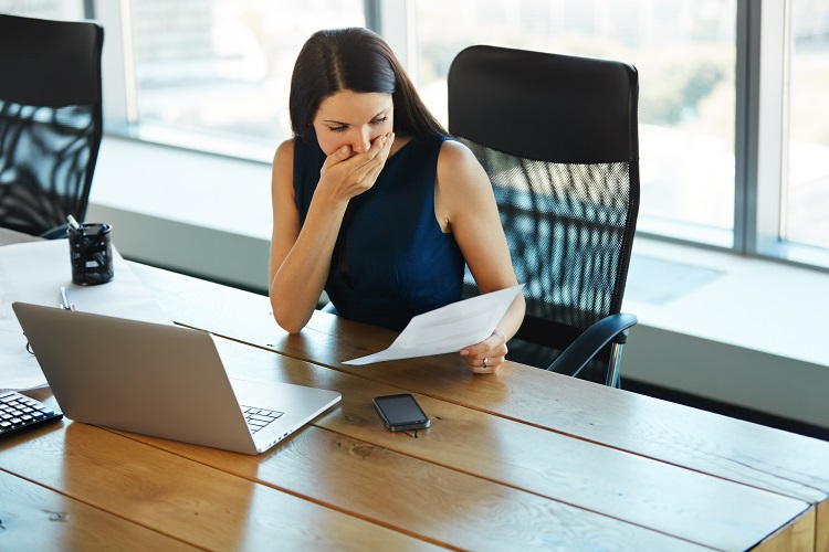 Woman at work struggling with addiction and other Substance Use Disorders