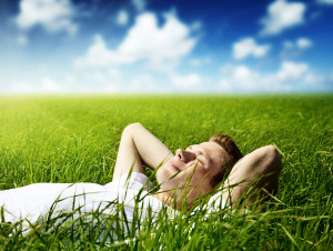 young man laying in grassy field