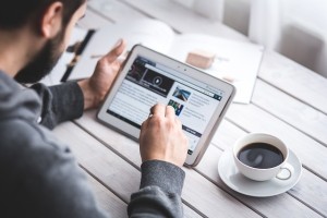 Male Employee At Work Using His Tablet