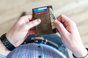 Man pulling money out of his wallet