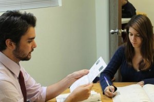 Young woman taking notes from her Therapist.