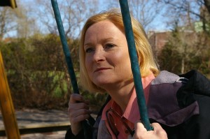 Middle aged Women sitting on a swing