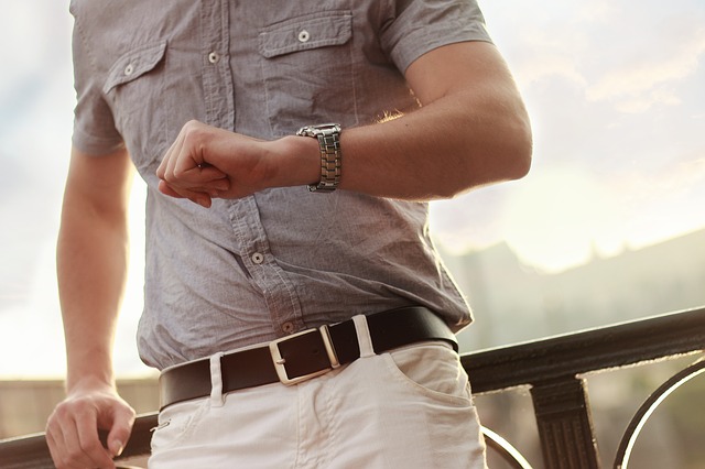 Man Looking At his Watch As He Runs Late