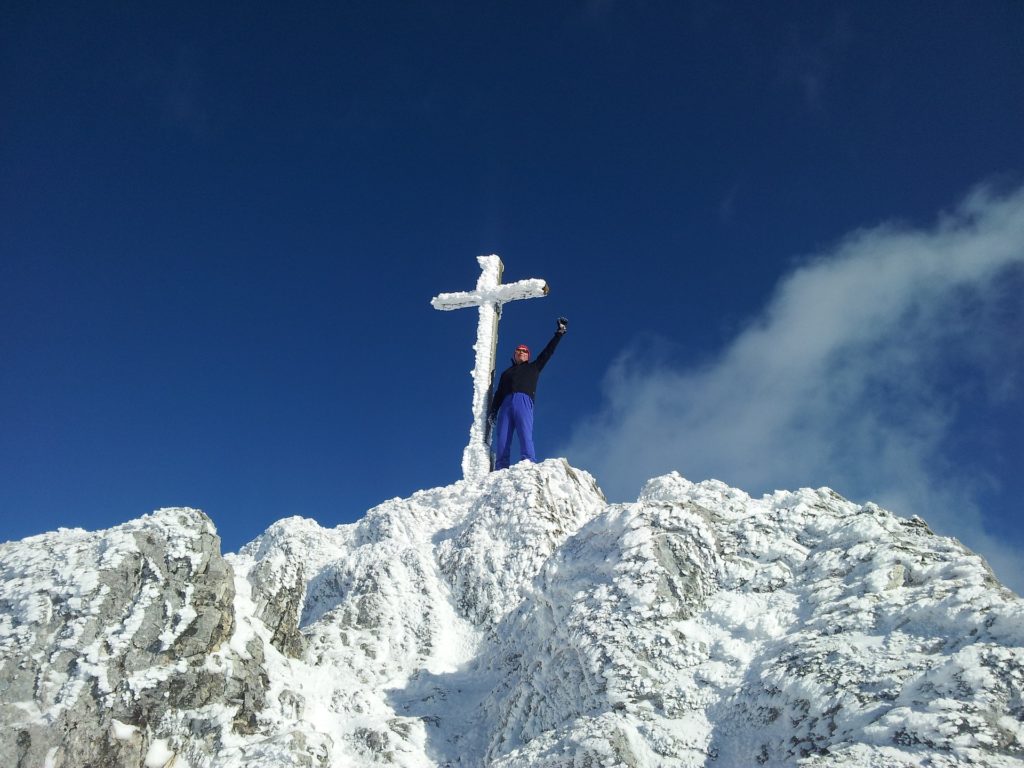 Man holding on to cross during the holidays