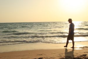 Man Considering treatment for sex addiction while walking on the beach