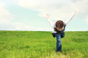 Child playing in the grass