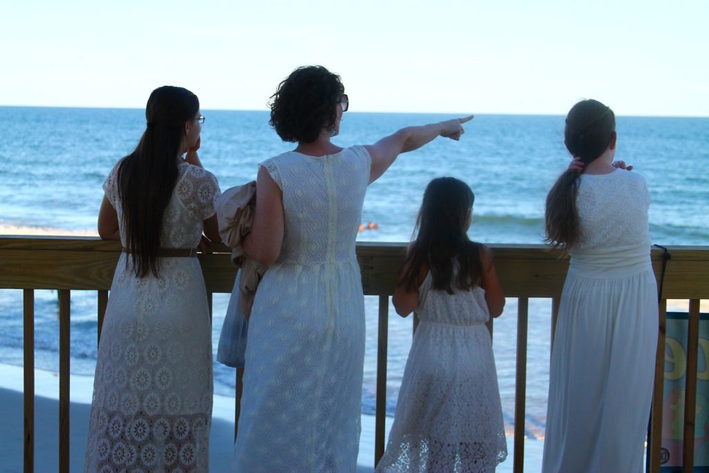 Mother and family looking at the ocean