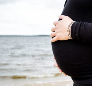 Pregnant woman by the ocean