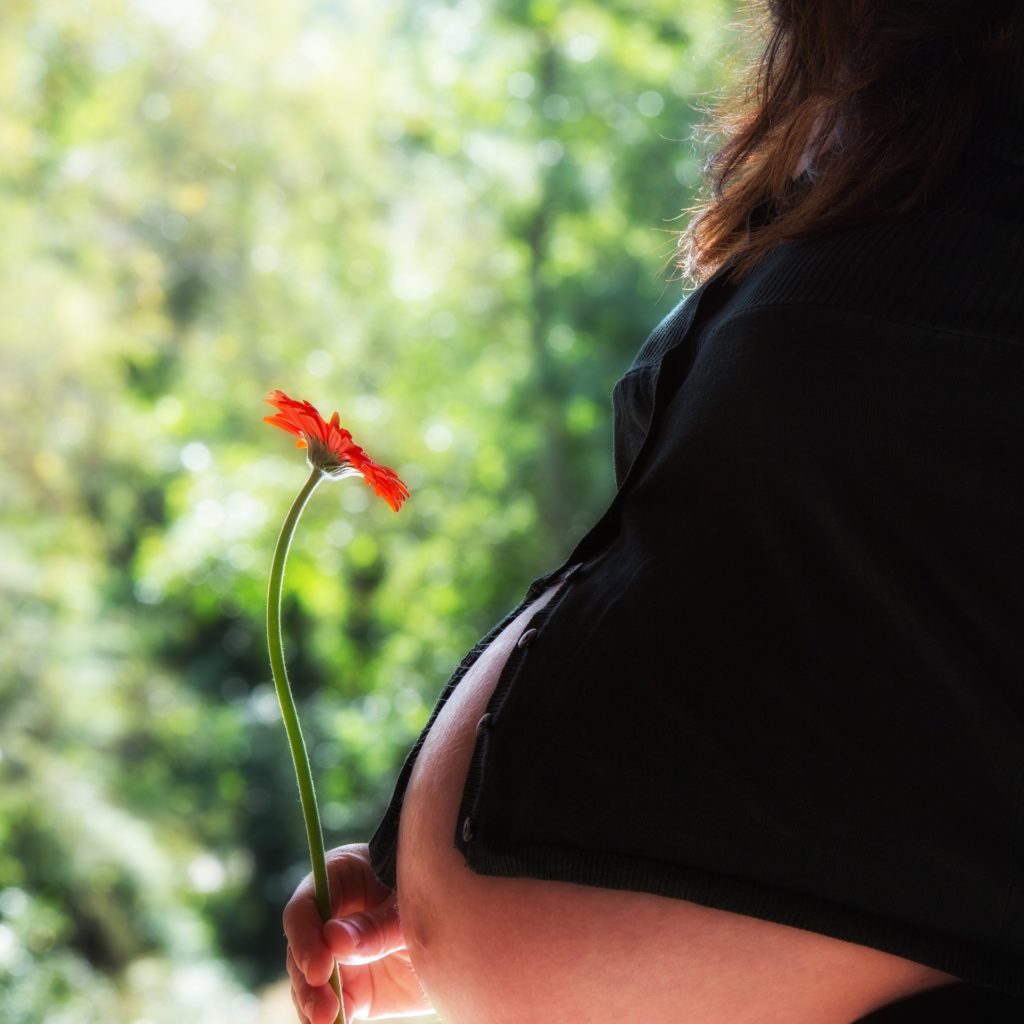 Pregnant woman with flower