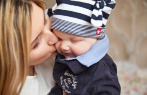 Mom kissing baby