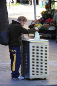 Man looking through garbage