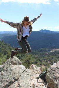 Woman jumping over rocks since she completed Treatment for Co-Occurring Disorders