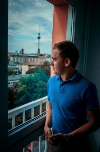 John standing by the window being judgmental