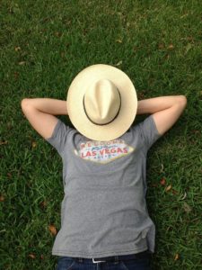 Man lying in the grass with a hat