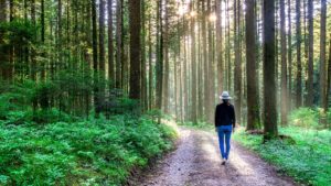 Woman walking path while in Addiction Recovery