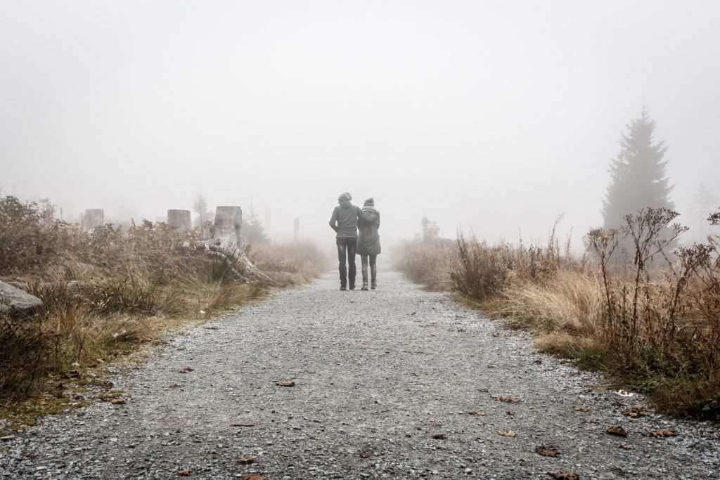 Couple walking in the fog