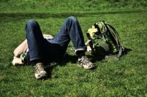 Man lying in the grass recovering from Alcohol Abuse