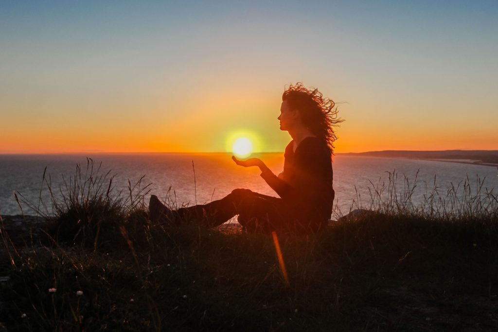 Woman holding the sun