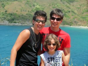 Three Brothers Standing By A Lake