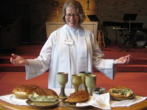 Pastor Standing Over Communion and helping in Addiction recovery