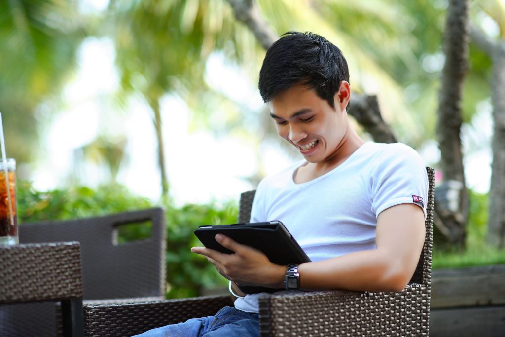 Man using tablet for Time Management in Addiction Recovery