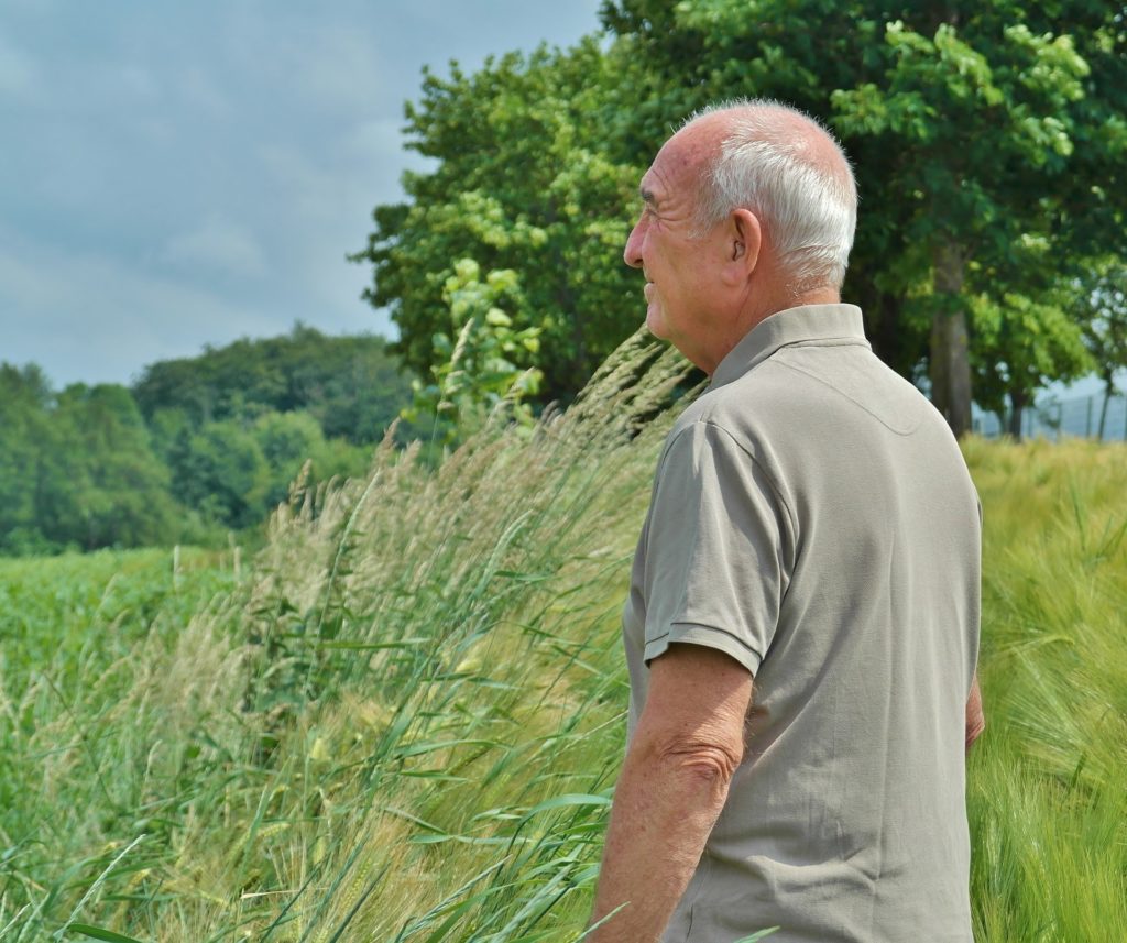 Senior standing in the grass