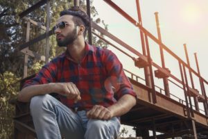 Man staring by a bridge thinking about Addiction Treatment