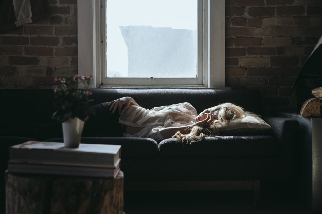 Woman lying on sofa