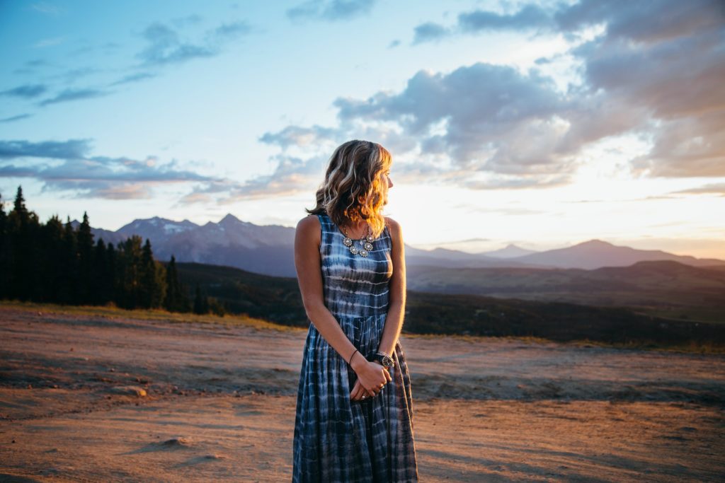 A woman standing in a field contemplating Middle-Aged Women in Addiction Recovery