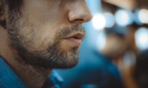 Man's face with beard fighting Cocaine addiction