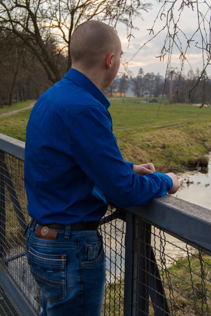 Man standing on a bridge struggling with addiction