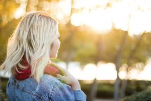 Woman in the sunset thinking about opioid treatment