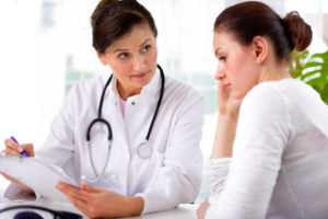 doctor with woman patient using Addiction Rehabilitation Center