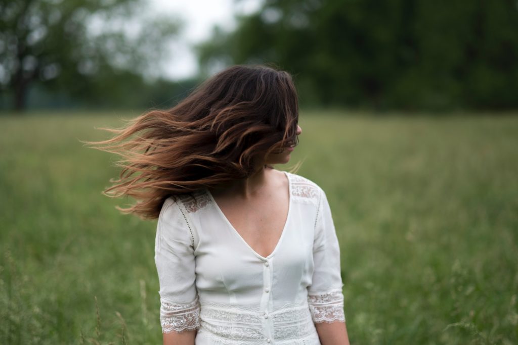 Lady in field thinking if her Substance Use Is a Problem