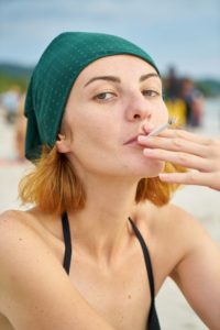 Woman smoking on the beach