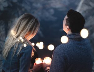 Couple sitting amongst the lights