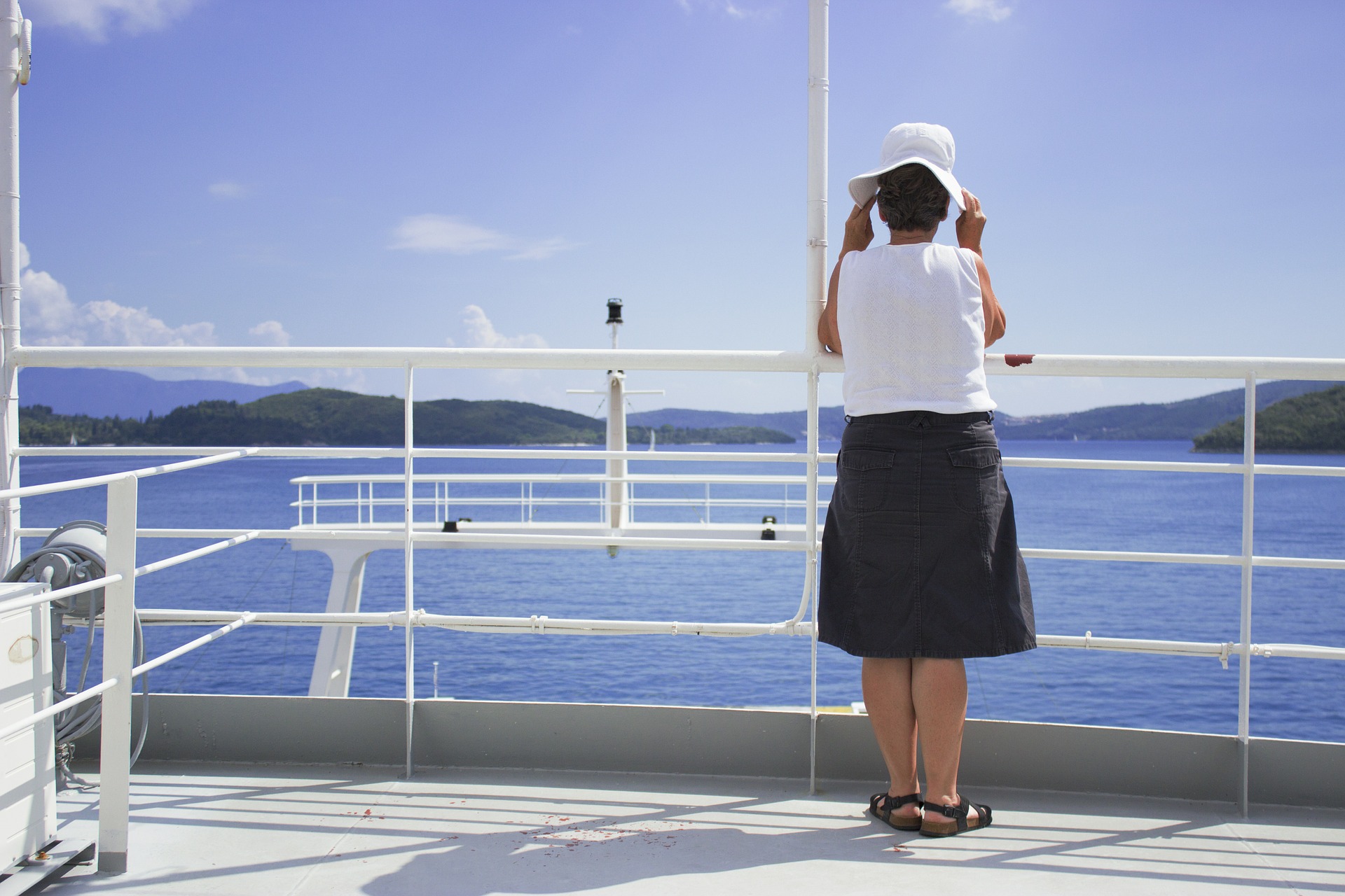 Older Woman standing on a deck of a ship contemplating ADHD