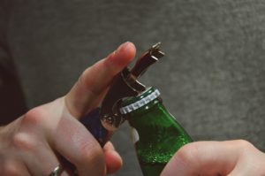 Woman opening a beer