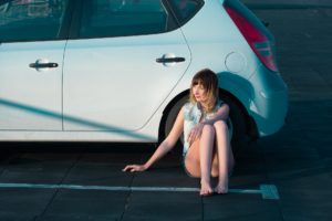 Woman sitting next to her car methadone addiction example