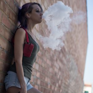 Teen Vaping Blowing Out Smoke