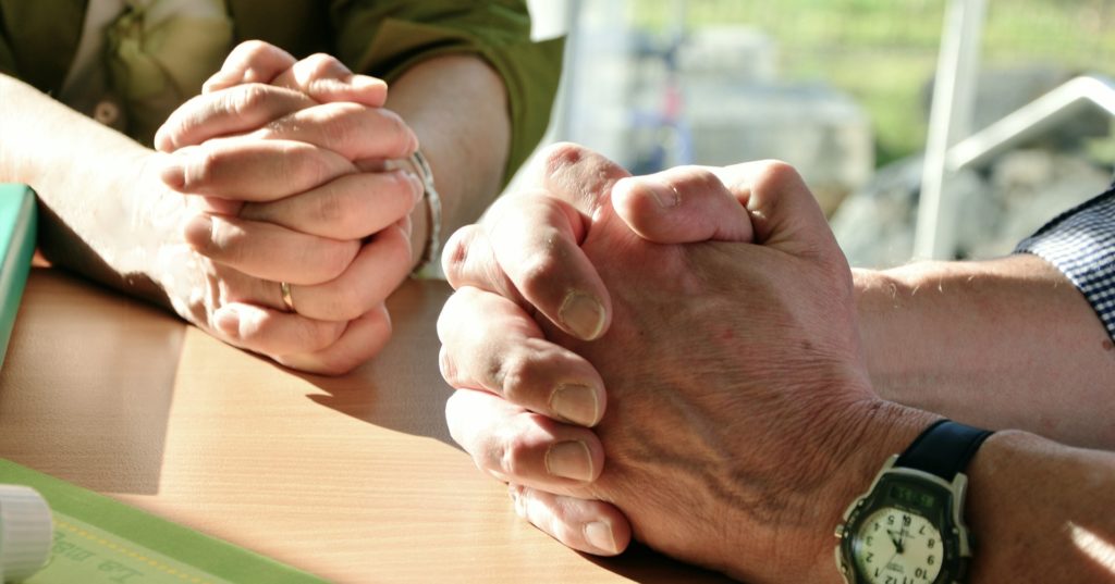 Hands of Older Couple Praying